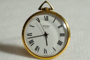 Gold edged clock with white face 